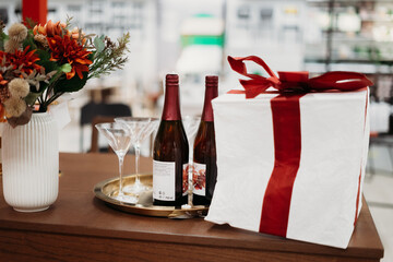 decoration of the New Year's table, champagne, wine, flowers, gifts