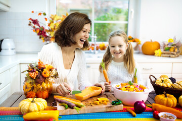 Family cooking pumpkin soup for Halloween lunch