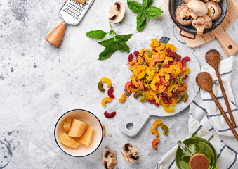 Pasta. italian pasta. Insalata di pasta and vegetables cooking ingredients, cheese, mushrooms and basil on old stone background. Italian food cooking ingredients. Top view with copy space.