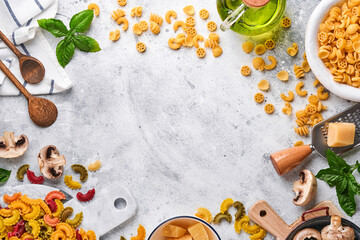 Pasta. italian pasta. Insalata di pasta and vegetables cooking ingredients, cheese, mushrooms and basil on old stone background. Italian food cooking ingredients. Top view with copy space.