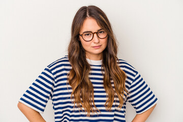 Young caucasian woman isolated on white background frowning face in displeasure, keeps arms folded.