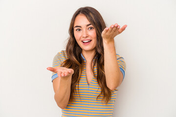 Young caucasian woman isolated on white background makes scale with arms, feels happy and confident.