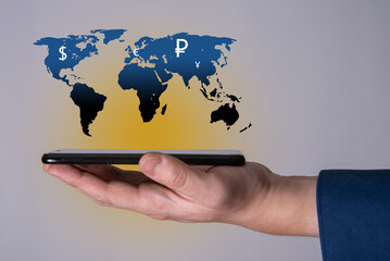 The phone and the map of the planet earth as an icon with currency signs of different countries of the world.