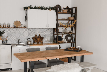 christmas kitchen interior design in a light Scandinavian style with a table and decoration made of natural materials