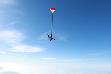 Skydiving. Tandem jump is in the amazing sky.