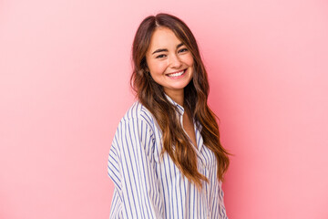 Fototapeta premium Young caucasian woman isolated on pink background confident keeping hands on hips.