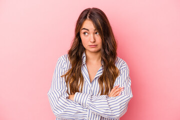 Fototapeta premium Young caucasian woman isolated on pink background tired of a repetitive task.
