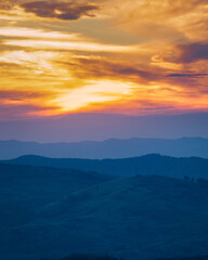 the curved hills seen to the sunset
