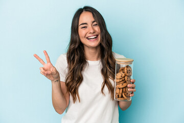 Young caucasian woman making a move isolated on yellow background joyful and carefree showing a peace symbol with fingers.