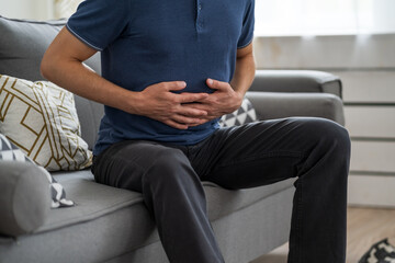 Stomach ache, man with abdominal pain suffering at home
