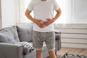 Stomach ache, man with abdominal pain suffering at home