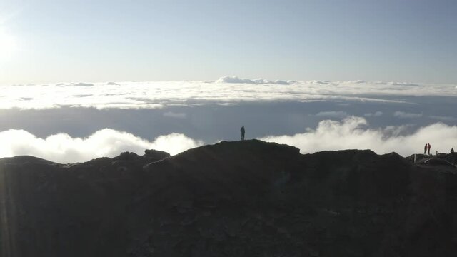 Aerial view of a beautiful sunset with clouds over the mountains near Piton de la Fournaise volcano in Saint Benoit, Reunion.
