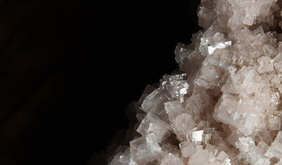 the crystals of crude sea salt are transparent with a pink tinge