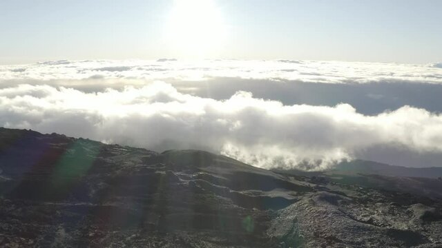 Aerial view of a beautiful sunset with clouds over the mountains near Piton de la Fournaise volcano in Saint Benoit, Reunion.