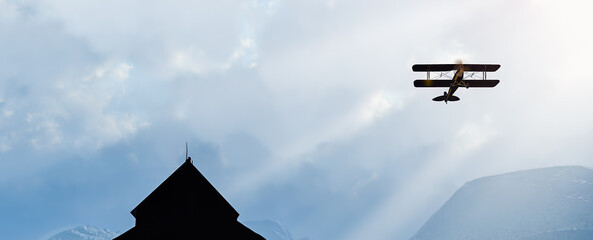 Vintage airplane  double wing biplane flying up through the clouds into the sky © Bob Orsillo