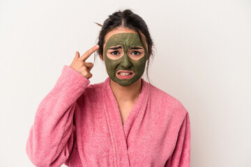 Young caucasian woman wearing a facial mask isolated on white background showing a disappointment gesture with forefinger.