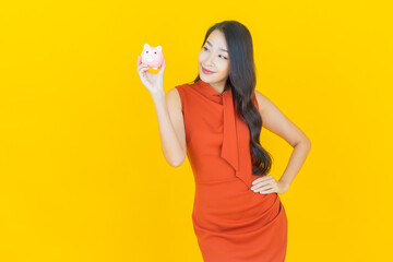 Portrait beautiful young asian woman with piggy bank