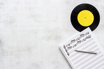 Sheets with music notes and vinyl record. Compose music concept