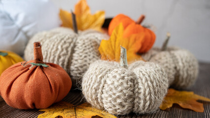 Hand made fabric pumpkin over grey knitted blanket for fall home decoration