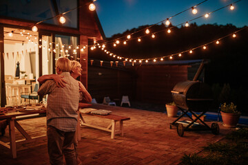 Loving senior couple dancing outdoors