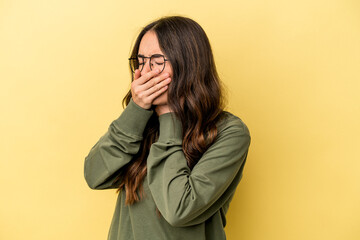 Young caucasian woman isolated on yellow background suffers pain in throat due a virus or infection.