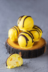 Truffles with mango and pineapple on a gray background. Sugar, gluten and lactose free and vegan.