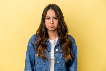Fototapeta premium Young caucasian woman isolated on yellow background sad, serious face, feeling miserable and displeased.