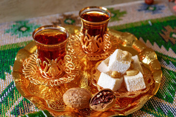 Turkish sweet baklava on metal tray with Turkish tea