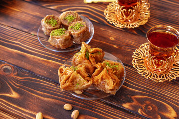 Turkish sweet baklava with Turkish tea on wooden background