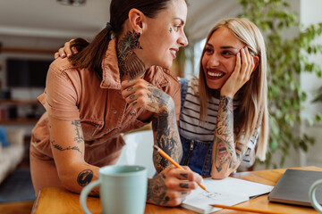 Lesbian women working together at home