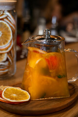 Sea buckthorn and dried fruits autumn tea on bokeh background.