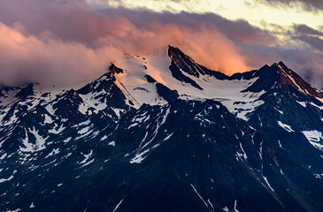 Fototapeta na wymiar Dramatic orange clouds over the Wilder Freiger mountain in austrian Stubai Alps.