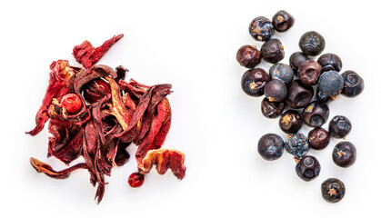 Winter spices isolated. Juniper berries and hibiscus flower spices on white background, top view....
