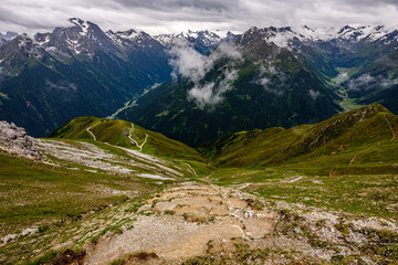 A mountain trail leading from Hoher Burgstall summit towards Starkenburger Hut in austrian Stubai Alps. 