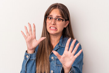 Young caucasian woman isolated on white background rejecting someone showing a gesture of disgust.