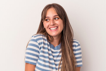 Fototapeta premium Young caucasian woman isolated on white background laughs and closes eyes, feels relaxed and happy.