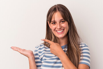 Young caucasian woman isolated on white background excited holding a copy space on palm.