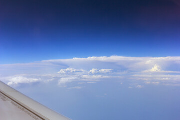 Fototapeta na wymiar White clouds and blue sky from plane