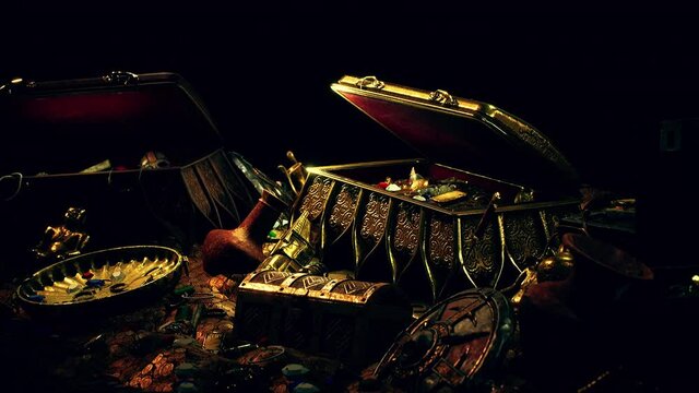 treasures in a dark cave with coins diamonds and gold