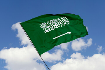 Saudi Arabia flag isolated on the blue sky background. close up waving flag of Saudi Arabia. flag symbols of Saudi Arabia. Concept of Saudi Arabia.