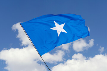 Somalia flag isolated on the blue sky background. close up waving flag of Somalia. flag symbols of...