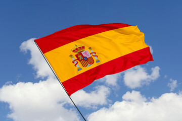 Spain flag isolated on the blue sky background. close up waving flag of Spain. flag symbols of Spain. Concept of Spain.