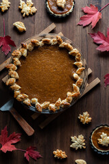 Obraz na płótnie Canvas Top down view of a homemade pumpkin pie with a decorative edge for Thanksgiving.