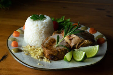 Decorated, delicious and colorful dish served with rice, salad, French fries and roast beef, decorated with fine herbs, photo seen from above