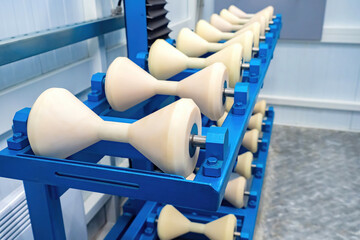 Roller supports for pipes. Tube roller tables close-up. Cones for moving and rotating round piles....