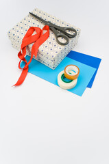 decorated paperboard box with lid on top and stationery on a white background
