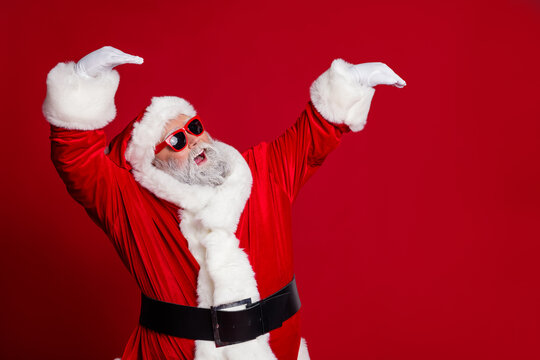 Portrait of attractive cheerful thick Santa dancing having fun fooling good mood isolated over bright red color background