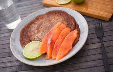 salted salmon fillet with rye pancakes and lime