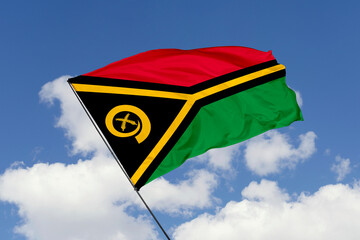 Vanuatu flag isolated on the blue sky background. close up waving flag of Vanuatu. flag symbols of Vanuatu. Concept of Vanuatu.