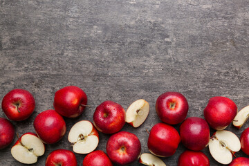 Fresh red apples with green leaves on wooden table. On wooden background. Top view free space for text